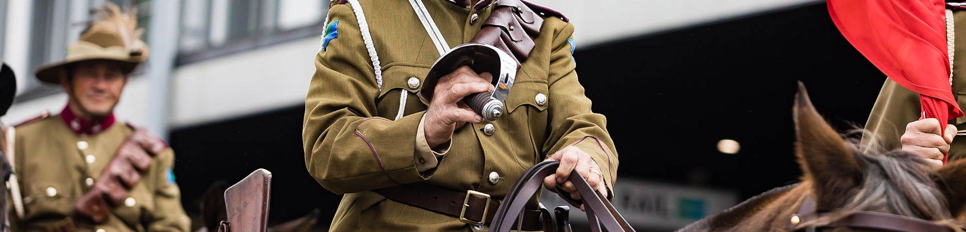 Army personnel on horse back riding in an ANZAC Day March