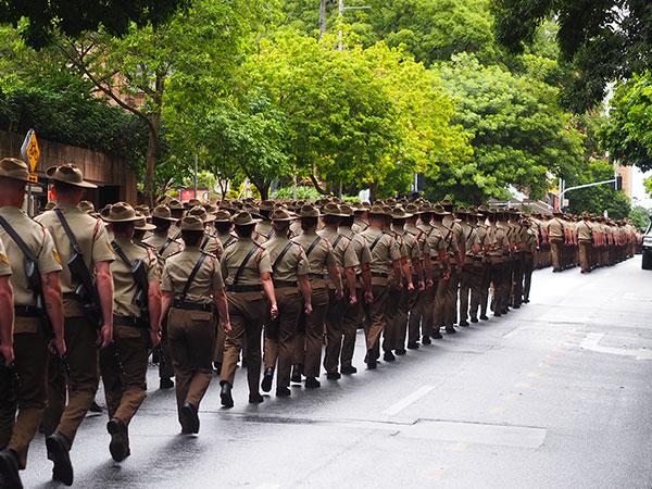 Army personnel lined up walking in a march